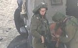 IDF soldiers handcuffing an 11-year-old Palestinian boy in Hebron, October 19, 2014. (screen capture: YouTube/B'Tselem)