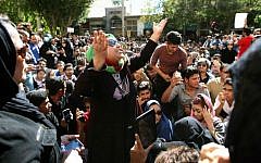 ILLUSTRATIVE PHOTO: Iranians take part in a protest in front of the judiciary building on October 22, 2014 in Isfahan,  in solidarity with women injured in a series of acid attacks (photo credit: AFP PHOTO/ISNA/Arya Jafari)