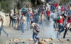 Illustrative photo of Palestinians clashing with Israeli soldiers, near the West Bank city of Ramallah, Sunday Oct. 26, 2014 (photo credit: STR/Flash90)