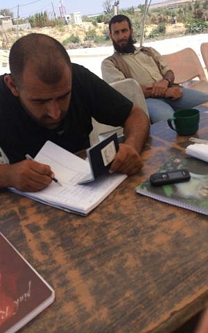 Hamas officials checking passport at Arba-Arba checkpoint at Beit Hanoun as Adam Kawalek entered Gaza. (Courtesy of Adam Kawalek)