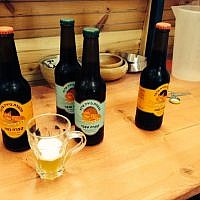 The Arava Brewery labels feature a jackal, one of the animals native to the region (photo credit: Jessica Steinberg/Times of Israel)