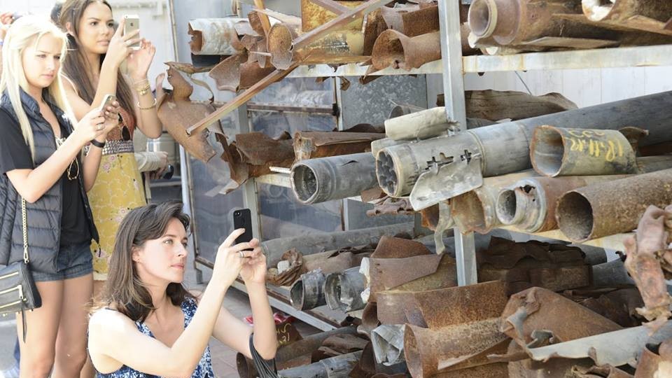 American beauty queens snap photos of a collection of rockets fired into Israel from Gaza. (photo credit: Face of Israel/Facebook)