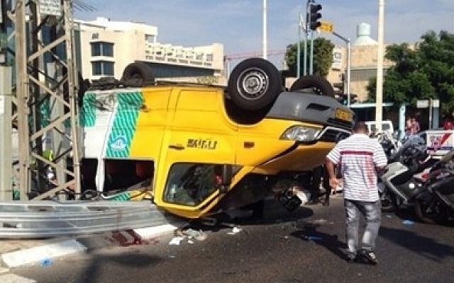 Shared taxi overturns on Jabotinsky street in Petah Tikva, killing one person and injuring 12, on October 8, 2014. (Photo credit: Magen David Adom) Shared taxi overturns on Jabotinsky street in Petah Tikva, killing one person and injuring 12, on October 8, 2014. (Photo credit: Magen David Adom)