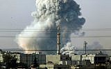 Smoke rises following an airstrike by the US-led coalition in Kobani, Syria, October 14, 2014. (AP Photo/Lefteris Pitarakis)