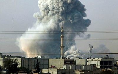 Smoke rises following an airstrike by the US-led coalition in Kobani, Syria, October 14, 2014. (AP Photo/Lefteris Pitarakis)