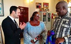 IsraAID's Yotam Polizer, left, meets with the first lady of Sierra Leone Sia Nyama Koroma, center, and Sam Bangura, her policy advisor, and presents them with gifts from Israel. (photo credit: courtesy IsraAID)