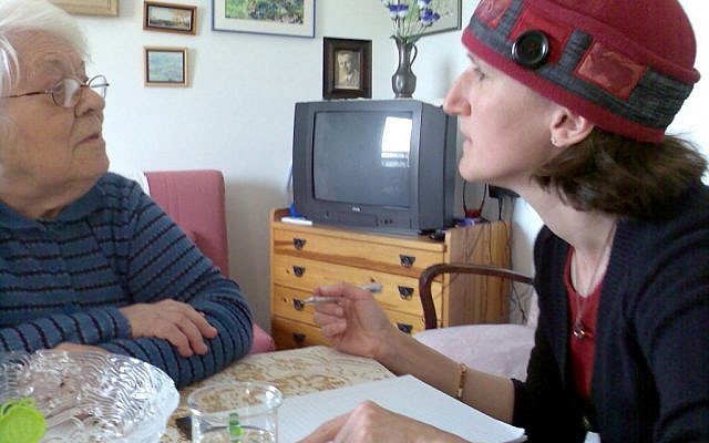 Aviv For Holocaust Survivors founder Aviva Silberman consults with a Holocaust survivor. (Courtesy)
