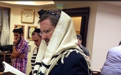 Yesh Atid MK Dov Lipman attends morning prayers at the Kehilat Bnei Torah synagogue in Har Nof, Jerusalem, on November 19, 2014. (photo credit: Courtesy)