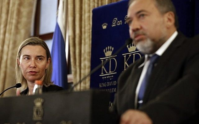 The European Union's new foreign affairs chief Federica Mogherini listens to Israeli Foreign Minister Avigdor Liberman during a press conference in Jerusalem, November 7, 2014. (photo credit: AFP/Thomas Coex) 