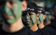 Young members of Hamas' Popular Army in a parade during a graduation ceremony in Jabaliya, in the northern Gaza Strip on November 7, 2014.  (Photo credit: AFP/Mohammed Abed)