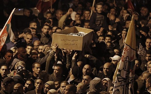 Palestinian mourners attend the funeral of bus driver Yusuf Hasan al-Ramuni in Abu Dis on November 17, 2014. (photo credit: AFP PHOTO / AHMAD GHARABLI) Palestinian mourners attend the funeral of bus driver Yusuf Hasan al-Ramuni in Abu Dis on November 17, 2014. (photo credit: AFP PHOTO / AHMAD GHARABLI)