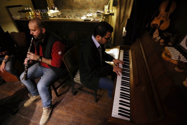 Syrian musicians perform at a pub restaurant in Aleppo in the government controlled side of the war-torn northern Syrian city on November 17, 2014 (photo credit: AFP/JOSEPH EID) Syrian musicians perform at a pub restaurant in Aleppo in the government controlled side of the war-torn northern Syrian city on November 17, 2014 (photo credit: AFP/JOSEPH EID)