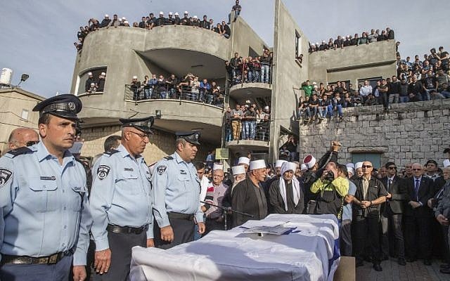 Police officers stand next to the coffin of Israeli police officer Zidan Saif, 30, a member of Israel's Druze minority, during his funeral in his northern home village of Yanuh-Jat, on November 19, 2014. Saif was killed during a terror attack on a Jerusalem synagogue the day before. (photo credit: AFP/Jack Guez) Police officers stand next to the coffin of Israeli police officer Zidan Saif, 30, a member of Israel's Druze minority, during his funeral in his northern home village of Yanuh-Jat, on November 19, 2014. Saif was killed during a terror attack on a Jerusalem synagogue the day before. (photo credit: AFP/Jack Guez)