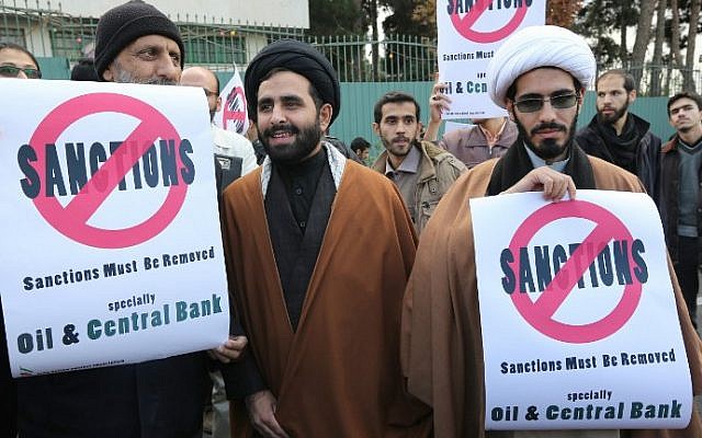 Iranian men hold placards during a demonstration outside the Tehran Research Reactor in the capital Tehran on November 23, 2014 to show their support for Iran's nuclear program. (photo credit: Atta Kenare/AFP) Iranian men hold placards during a demonstration outside the Tehran Research Reactor in the capital Tehran on November 23, 2014 to show their support for Iran's nuclear program. (photo credit: Atta Kenare/AFP)