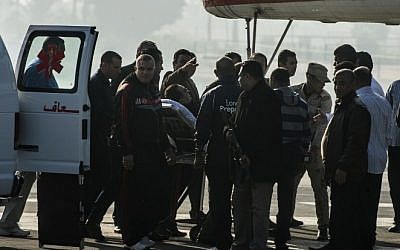 Egypt's former president Hosni Mubarak is wheeled on a bed from an ambulance to a medical helicopter outside Maadi military hospital as he heads to the court in Cairo for his trial on November 29, 2014. (Photo credit:AFP / KHALED DESOUKI)