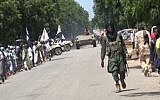 File: A screen capture taken on November 9, 2014 from a new video released by the Nigerian Islamist extremist group Boko Haram and obtained by AFP shows Boko Haram fighters parading with a tank in an unidentified town. (AFP/HO/Boko Haram)