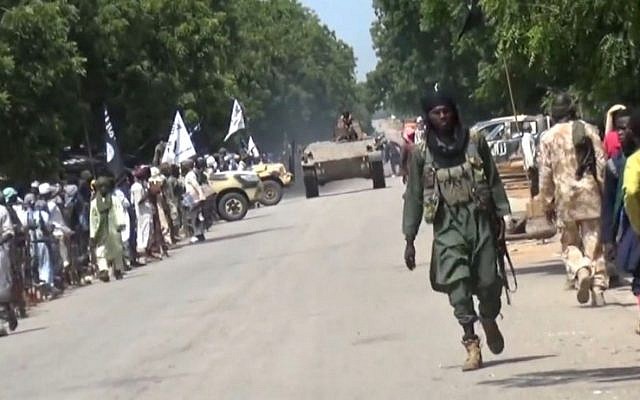 File: A screen capture taken on November 9, 2014 from a new video released by the Nigerian Islamist extremist group Boko Haram and obtained by AFP shows Boko Haram fighters parading with a tank in an unidentified town. (AFP/HO/Boko Haram) File: A screen capture taken on November 9, 2014 from a new video released by the Nigerian Islamist extremist group Boko Haram and obtained by AFP shows Boko Haram fighters parading with a tank in an unidentified town. (AFP/HO/Boko Haram)