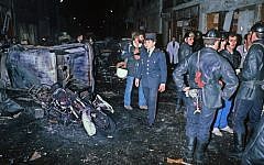 A file picture taken on October 3, 1980 shows firefighters standing by the wreckage of a car and motorcycle after a bomb attack at a Paris synagogue on Rue Copernic which killed four people. (Photo credit: AFP)