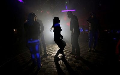 A file picture taken on November 15, 2014, shows Syrians dancing at a night club in the government-controlled part of the northern city of Aleppo (phoro credit: AFP/JOSEPH EID)
