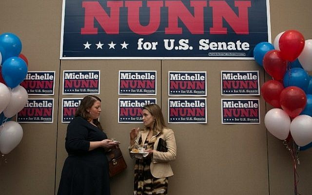 Ally O'Callaghan (left) and Catherine Fitch socialize and await results at the election party for Georgia Democratic US Senate candidate Michelle Nunn with other supporters at the Hyatt Regency in downtown Atlanta on November 4, 2014 in Atlanta, Georgia. Nunn is running a tight race against Republican candidate David Perdue. (Photo credit: Jessica McGowan/Getty Images/AFP) Ally O'Callaghan (left) and Catherine Fitch socialize and await results at the election party for Georgia Democratic US Senate candidate Michelle Nunn with other supporters at the Hyatt Regency in downtown Atlanta on November 4, 2014 in Atlanta, Georgia. Nunn is running a tight race against Republican candidate David Perdue. (Photo credit: Jessica McGowan/Getty Images/AFP)