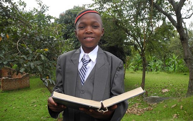 Keki's son Aaron took over the Luganda translation duties from his father for the mass Bar Mitzvah. (Melanie Lidman/Times of Israel)
