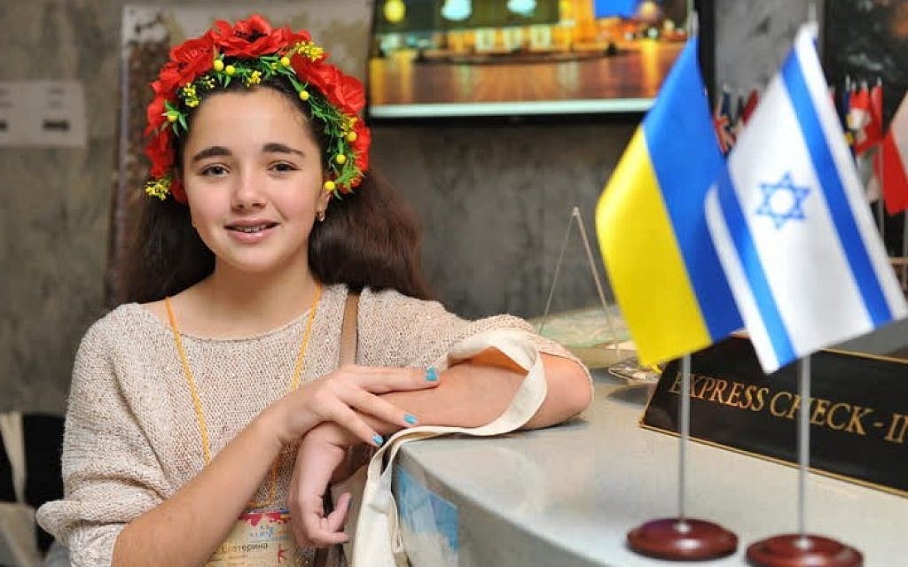 A Jewish girl wearing a traditional Ukrainian wreath, or 'vinok,' stands in the lobby of Lviv's Dnister Hotel, where Israeli and Ukrainian flags stand side-by-side during the Limmud FSU conference in Lviv, Ukraine, November 6-10, 2014. (photo credit: Yossi Aloni) A Jewish girl wearing a traditional Ukrainian wreath, or 'vinok,' stands in the lobby of Lviv's Dnister Hotel, where Israeli and Ukrainian flags stand side-by-side during the Limmud FSU conference in Lviv, Ukraine, November 6-10, 2014. (photo credit: Yossi Aloni)