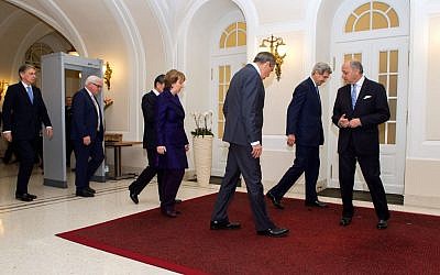 Foreign Ministers from the P5+1 nations - Philip Hammond of the United Kingdom, Frank-Walter Steinmeier of Germany, Wang Yi of China, Baroness Catherine Ashton of the European Union, Sergey Lavrov of Russia, John Kerry of the United States, and Laurent Fabius of France - look for their place marks before taking a "family photo" in Vienna, Austria, on November 24, 2014. (photo credit: US State Department)