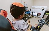 A young paralyzed boy uses the Sesame Enable phone (Courtesy)
