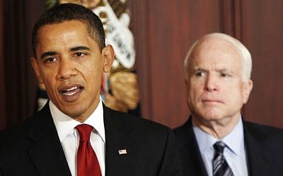 In this March 4, 2009 file photo, Sen. John McCain, R-Ariz., looks on as President Barack Obama makes remarks on government contracts reform in the Eisenhower Executive Office Building on the White House campus in Washington. (photo credit: AP Photo/Gerald Herbert, File)