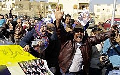 Supporters of former Egyptian President Hosni Mubarak celebrate after hearing the verdict of his trial outside a police academy on the outskirts of Cairo, Saturday, Nov. 29, 2014. The court on Saturday dismissed murder charges against Mubarak in connection with the killing of protesters in the 2011 uprising that ended his nearly three-decade reign. (photo credit: AP/Ahmed Abd El-Latif, El Shorouk Newspaper)