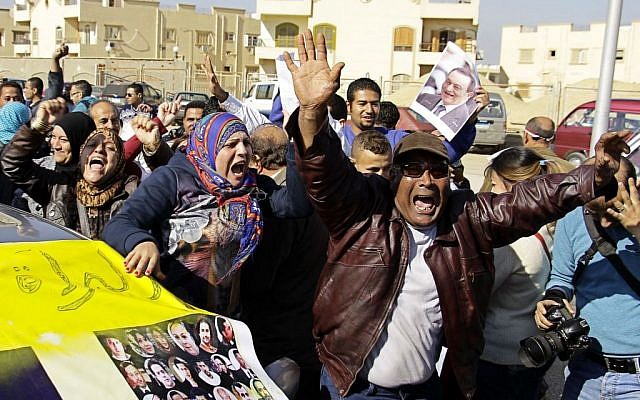 Supporters of former Egyptian President Hosni Mubarak celebrate after hearing the verdict of his trial outside a police academy on the outskirts of Cairo, Saturday, Nov. 29, 2014. The court on Saturday dismissed murder charges against Mubarak in connection with the killing of protesters in the 2011 uprising that ended his nearly three-decade reign. (photo credit: AP/Ahmed Abd El-Latif, El Shorouk Newspaper) Supporters of former Egyptian President Hosni Mubarak celebrate after hearing the verdict of his trial outside a police academy on the outskirts of Cairo, Saturday, Nov. 29, 2014. The court on Saturday dismissed murder charges against Mubarak in connection with the killing of protesters in the 2011 uprising that ended his nearly three-decade reign. (photo credit: AP/Ahmed Abd El-Latif, El Shorouk Newspaper)