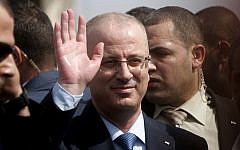 Palestinian Authority Prime Minister Rami Hamdallah waves to citizens during his visit to Beit Hanoun in the northern Gaza Strip, October 9, 2014. (photo credit: Abed Rahim Khatib/Flash90)