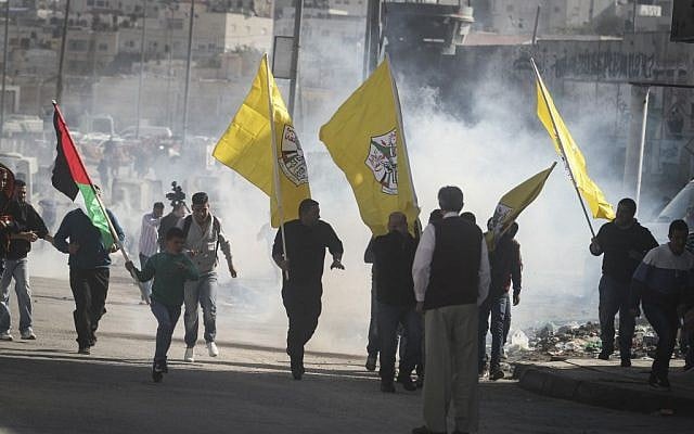 Clashes between Israeli forces and Palestinian protesters carrying Fatah flags following a rally on November 2, 2014 at the Qalandia checkpoint north of Jerusalem (photo credit: Issam Rimawi/Flash90) Clashes between Israeli forces and Palestinian protesters carrying Fatah flags following a rally on November 2, 2014 at the Qalandia checkpoint north of Jerusalem (photo credit: Issam Rimawi/Flash90)