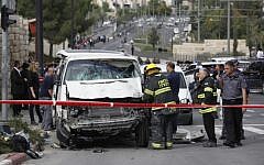 Israeli security personnel at the site where an Arab man from the East Jerusalem neighborhood of Shuafat drove his car into a crowd of people waiting at a Jerusalem Light Rail station, November 5, 2014. (photo credit: Yonatan Sindel/Flash90)