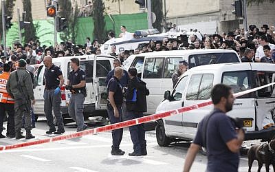 Israeli security personnel at the site where an Arab man from the East Jerusalem neighborhood of Shuafat drove his car into a crowd of people waiting by the Shimon ha Tzadik light rail station in Jerusalem injuring at least 8 people, and killing one bystander, November 05, 2014. (photo credit: Yonatan Sindel/FLASH90)