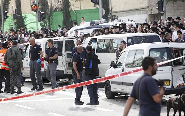 Israeli security personnel at the site where an Arab man from the East Jerusalem neighborhood of Shuafat drove his car into a crowd of people waiting by the Shimon ha Tzadik light rail station in Jerusalem injuring at least 8 people, and killing one bystander, November 05, 2014. (photo credit: Yonatan Sindel/FLASH90) Israeli security personnel at the site where an Arab man from the East Jerusalem neighborhood of Shuafat drove his car into a crowd of people waiting by the Shimon ha Tzadik light rail station in Jerusalem injuring at least 8 people, and killing one bystander, November 05, 2014. (photo credit: Yonatan Sindel/FLASH90)