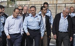 Mayor Nir Barkat, left, and Israel Police chief Yohanan Danino, center, at the site where an Arab man from the East Jerusalem neighborhood of Shuafat drove his car into a crowd of people waiting at a light rail station in Jerusalem, November 5, 2014. (photo credit: Yonatan Sindel/FLASH90)