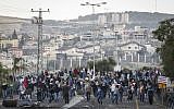 Israeli Arabs seen waving Palestinian and Hamas flags and throwing rocks towards Israeli border policemen at the entrance to the Arab village of Kafr Kanna in northern Israel, on November 8, 2014.  (photo credit: Hadas Parush/Flash90)