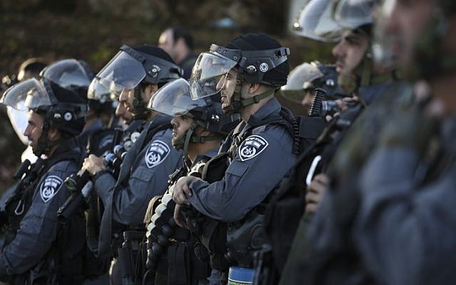 Israeli police officers wait for command to advance towards rioters throwing rocks during clashes at the entrance to the Arab village of Kfar Kanna, in northern Israel, on November 8, 2014. (photo credit: Hadas Parush/Flash90) Israeli police officers wait for command to advance towards rioters throwing rocks during clashes at the entrance to the Arab village of Kfar Kanna, in northern Israel, on November 8, 2014. (photo credit: Hadas Parush/Flash90)