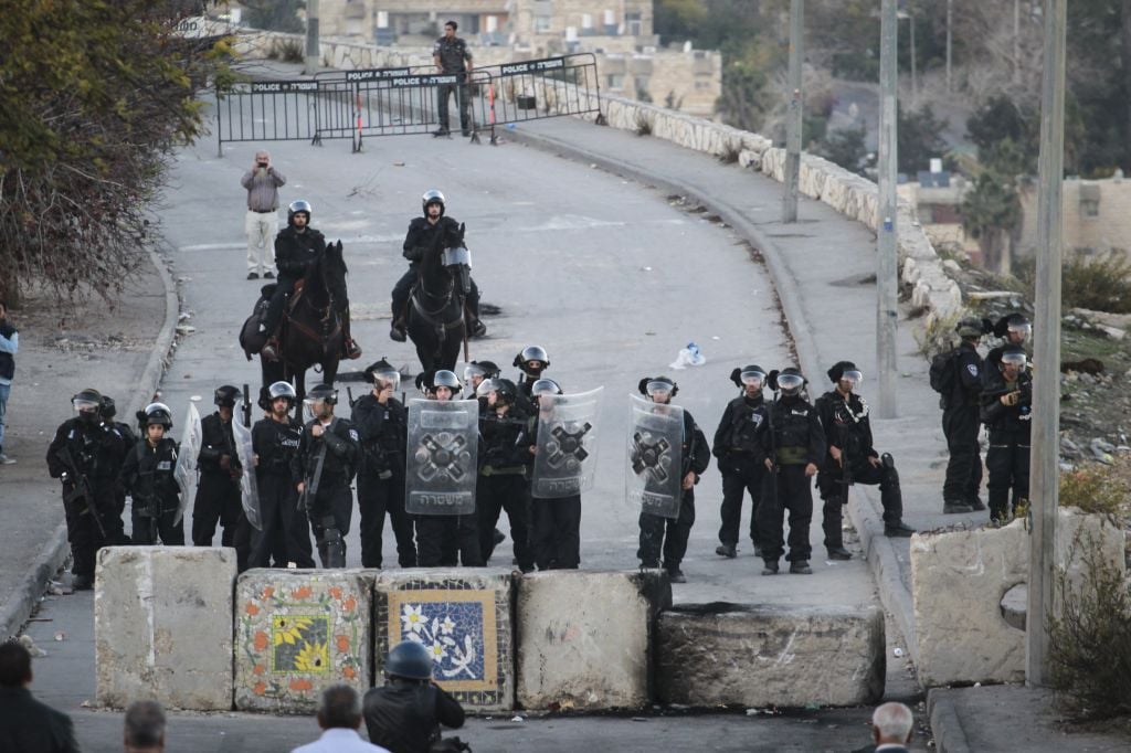 Israeli Border Police guard at the new cement blocks at the entrance to Issawiya, in East Jerusalem on November 12, 2014. (photo credit: Hadas Parush/Flash90)
