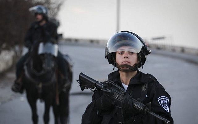 An Israeli Border Policewoman stands guard during a demonstration in Issawiya, East Jerusalem, against the new cement blockades at the entrances to the neighborhood, on November 12, 2014. (Photo credit: Hadas Parush/Flash90) An Israeli Border Policewoman stands guard during a demonstration in Issawiya, East Jerusalem, against the new cement blockades at the entrances to the neighborhood, on November 12, 2014. (Photo credit: Hadas Parush/Flash90)