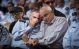 Police chief Yohanan Danino, left, whispering in the ear of Public Security Minister Yitzhak Aharonovitch on Thursday November 13, 2014. (photo credit: Miriam Alster/Flash90)