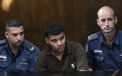 Nur al-Din Abu Khashiyeh (C), indicted for stabbing to death IDF soldier Almog Shiloni, seen at court in Tel Aviv as he arrives for a hearing on November 24, 2014. (Flash90) Nur al-Din Abu Khashiyeh (C), indicted for stabbing to death IDF soldier Almog Shiloni, seen at court in Tel Aviv as he arrives for a hearing on November 24, 2014. (Flash90)