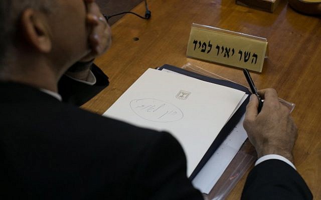A piece of paper in front of Finance Minister Yair Lapid during the weekly cabinet meeting reads, in handwritten Hebrew, 'National State Law,' Sunday, November 23, 2014. (photo credit: Ohad Zwigenberg/POOL) A piece of paper in front of Finance Minister Yair Lapid during the weekly cabinet meeting reads, in handwritten Hebrew, 'National State Law,' Sunday, November 23, 2014. (photo credit: Ohad Zwigenberg/POOL)
