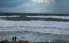 Israelis look at the sea during a rainstorm in the city of Ashkelon on November 26, 2014. (photo credit: Edi Israel/Flash 90)