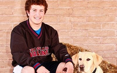 Gabe Baskin with Collier, the puppy he is currently training for guide dog school. (Courtesy of Gabe Baskin/JTA)