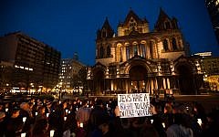 More than 150 Boston-area Jews gathered in front of the city's Trinity Church yesterday for a vigil to remember the victims of last week's Jerusalem synagogue terror attack (photo credit: Elan Kawesch/The Times of Israel)