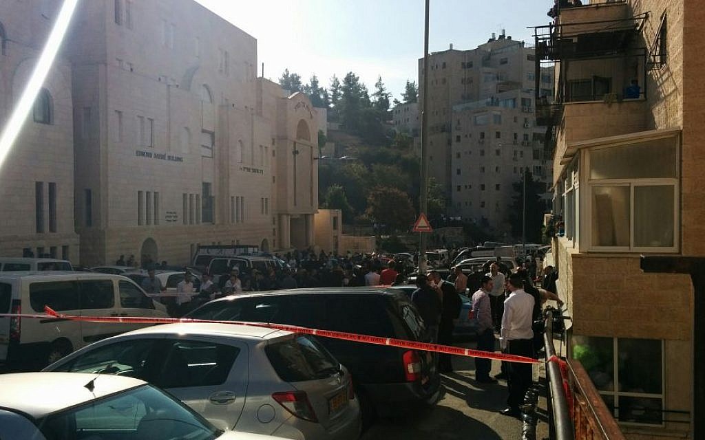 People outside the scene of a terror attack in Jerusalem's Har Nof neighborhood on November 18, 2014. (photo credit: Marissa Newman / Times of Israel)
