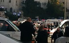Israeli police and rescue workers outside the Kehilat Yaakov synagogue in Jerusalem after a terror attack there on November 18, 2014 in which three US citizens and a British national were killed. (photo credit:  Marissa Newman/Times of Israel)