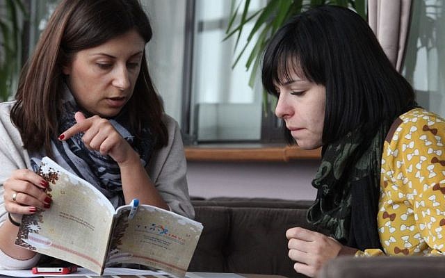 Limmudniks go over the conference program at the Dnister Hotel, Lviv, Ukraine, November 2014. (photo credit: Yossi Aloni) Limmudniks go over the conference program at the Dnister Hotel, Lviv, Ukraine, November 2014. (photo credit: Yossi Aloni)